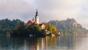 Famous Bled Lake in Triglav National Park in the Julian Alps  in autumn colors at sunrise in Slovenia,Europe. 4K video 