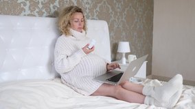 Pregnant Woman Reading About Medicine In Internet Using Laptop.