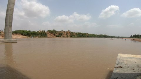 Wide, panning, a bridge over river Betwa, Ratangarh, India