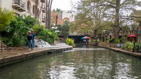 San Antonio, Texas - November 30, 2019: Time Lapse of the San Antonio River Boats Show casing Shops around the River Walk