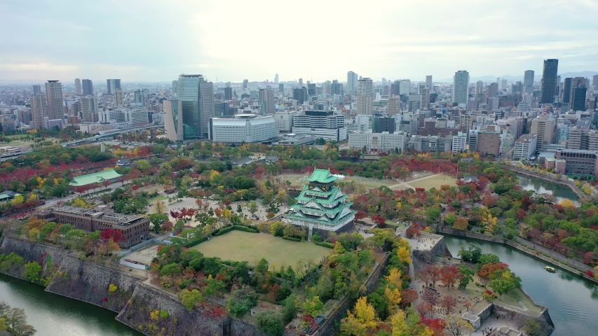 Aerial view 4k by drone of Osaka castle and building city at Osaka, japan in autumn. Royalty-Free Stock Footage #1042857004