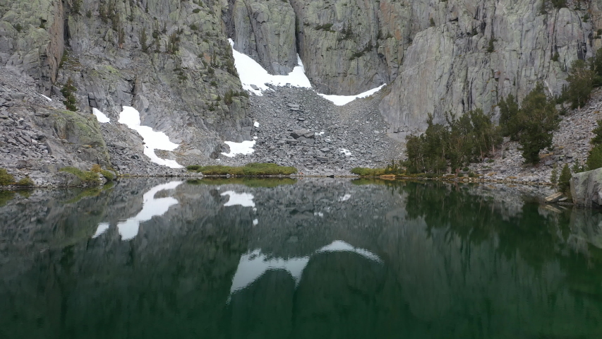 Aerial beautiful shot over pristine alpine lake in Eastern Sierra, California