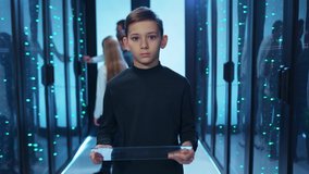Smart kid boy browsing virtual interface on invisible tablet, programming for server diagnostics at database. Prodigy teenager working in team at data center cyberspace. - Powered by Shutterstock - Get 15% off with code: PIKWIZARD15