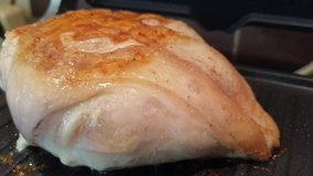 cooking chicken fillet on electric grill, video filmed on a mobile phone