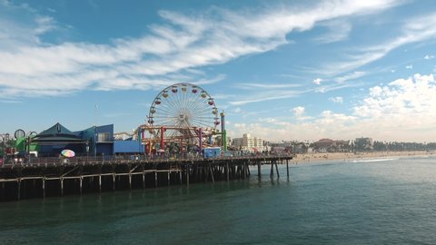 Santa Monica, United States - November 26, 2019: Angelenos and tourists visit the Pacific Park of the Santa Monica Pier. The solar powered ferris wheel shows a commitment to the environment. Holidays.