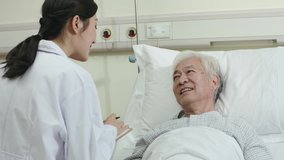 friendly young asian female doctor talking to male senior patient at bedside in hospital ward - Powered by Shutterstock - Get 15% off with code: PIKWIZARD15