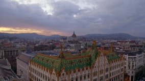 Amazing roof in Budapest, Hungary, Europe. State Treasury building with Hungarian Parliament in winter time.  All tiles on the roof made from the world famous Zsolnay pyro granite.