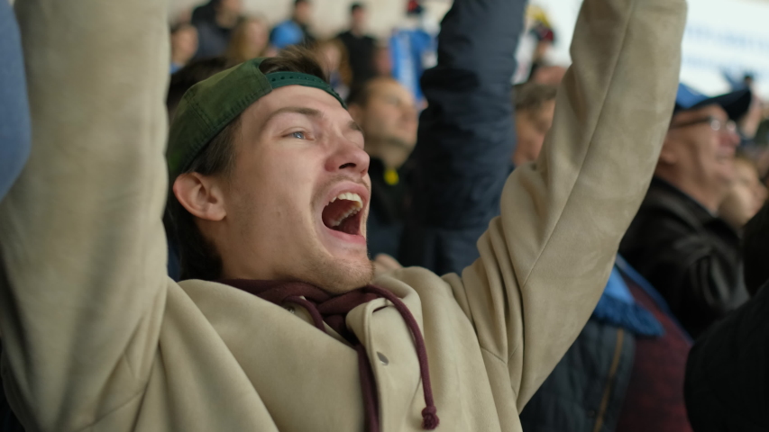 Male spectator sport hockey match joy goal win closeup happy fan expressive scream background crowd 4K. People with friend hockey game cheering winning team. Fan man scream happy goal favorite team. Royalty-Free Stock Footage #1042881832