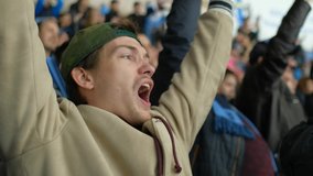 Male spectator sport hockey match joy goal win closeup happy fan expressive scream background crowd 4K. People with friend hockey game cheering winning team. Fan man scream happy goal favorite team. - Powered by Shutterstock - Get 15% off with code: PIKWIZARD15