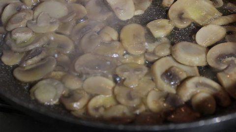 Close-up, Champignon mushrooms when cooked in a pan. Slowly dolly shot