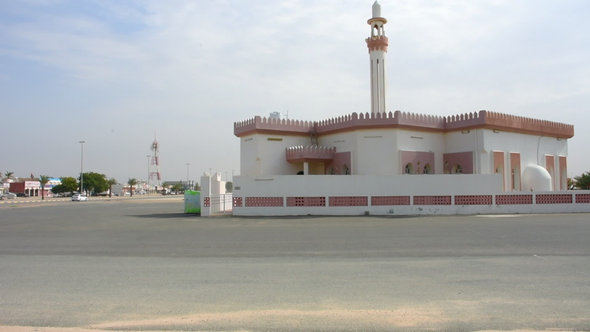 White Mosque in a residential area in the Middle East on a cloudy afternoon in the late afternoon sunshine during call to prayer. Royalty-Free Stock Footage #1042883293