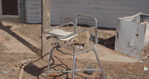 Rusted metal baby high chair, left behind in the abandoned town of Olary, 400kms north-east of Adelaide, South Australia, Australia