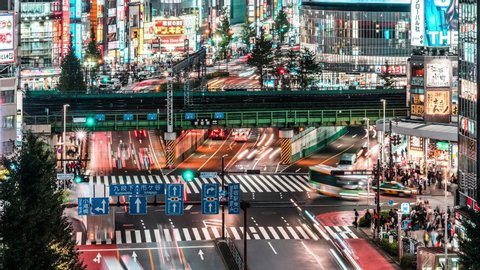 Tokyo, Japan - Nov 1, 2019: time lapse of car traffic and train transport at Kabukicho district in Shinjuku, Tokyo night cityscape high angle view, zoom out. Japan tourist attraction, Asian city life