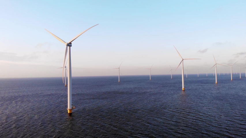 Aerial view at windmill park during sunset in the Netherlands, green energy wind mill turbines | Shutterstock HD Video #1042888555