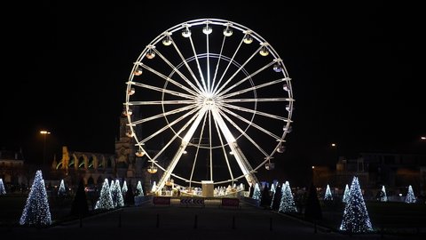 Large wheel illuminated observation set in front of the city hall of Caen in Basse Normandie at night. 4k 25ftp. Light illumination