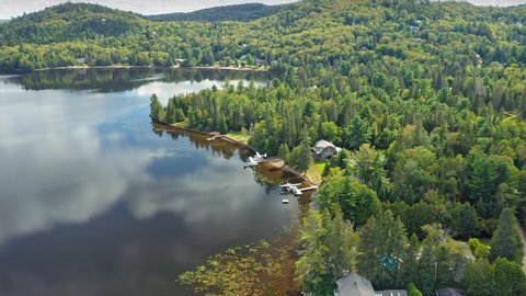 Aerial: Forest & calm tranquil Lac Raymond in Val Morin Laurentian Mountains near Montreal, Quebec, Canada 