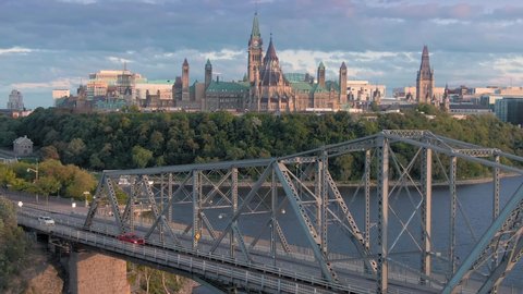 Aerial: Alexandria Bridge crossing the Ottawa River. In the background is the Library of Parliament. Ottawa, Ontario, Canada. 11 September 2019 