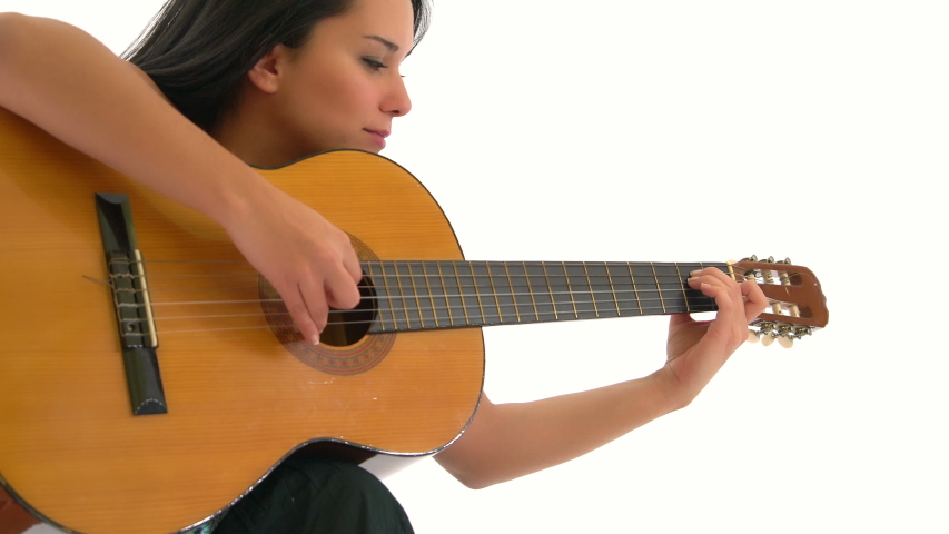 Young Woman Playing Guitar Emotionally, Isolated in White Background Studio Royalty-Free Stock Footage #1042897567