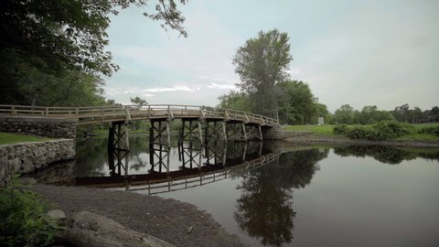 Wide shot of the Old North Bridge with reflection in Concord River