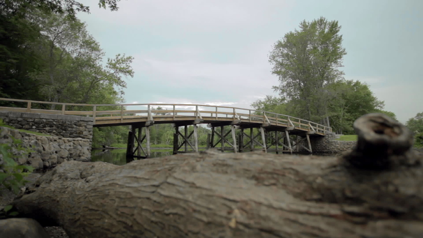 Old North Bridge with tree log in foreground shallow depth of field