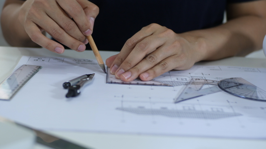 Close up and dolly shot of Engineers are drawing house plans to offer customers | Shutterstock HD Video #1042904773