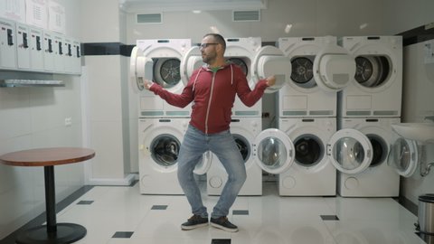 Man Dancing Swing And Have Fun In the Laundry  Room. Happy Man Enjoying Dance, Having Fun Together, Party. Floss Dance Viral, Flossing, swing.