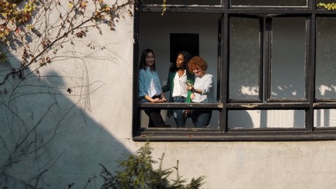 Students taking a selfie at open window