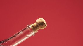  Slow motion of champagne cork exploding from bottle. Close-up of champagne or sparking coctail. On red background.
 - Powered by Shutterstock - Get 15% off with code: PIKWIZARD15
