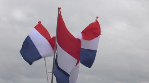 Three Dutch flags in the wind in Scheveningen