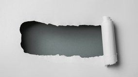 Gray paper is torn over dark background for message, stop motion, animation.  - Powered by Shutterstock - Get 15% off with code: PIKWIZARD15