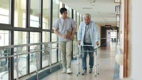 young asian physical therapist working with senior man on walking using a walker in rehab center or nursing home - Powered by Shutterstock - Get 15% off with code: PIKWIZARD15