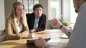 Businessman showing real-estate project to couple of clients