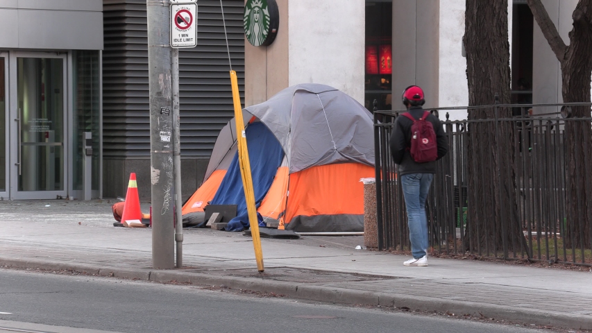 Toronto, Ontario, Canada December 2019 Homeless people in tents on streets of wealthy Toronto financial and tech district | Shutterstock HD Video #1042934893