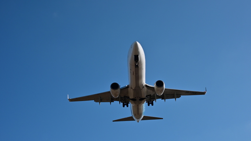 4K Airplane flying overhead against blue sky | Shutterstock HD Video #1042935790