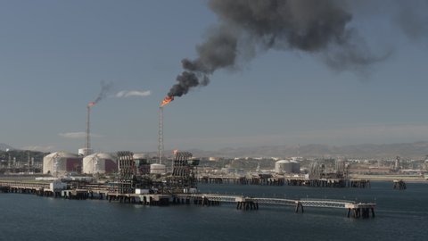 Gas flare of refineries in the petrochemical terminal on sea shore Arzew Algeria 12.01.2019