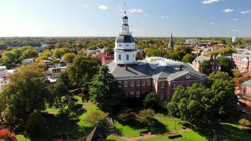 Slow orbiting aerial of the Maryland State House in Annapolis, Maryland on beautiful autumn day