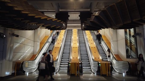 
Sydney NSW Australia - Dec 11 2019: commuter walk under The artwork escalator sculpture " Interloop " by artist Chris Fox  at  West exit of Wynyard Train Station. 