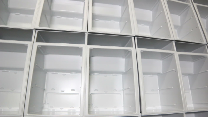 Closeup motion aside past rows with finished fridge white bodies without doors and shelves in workshop | Shutterstock HD Video #1042958017