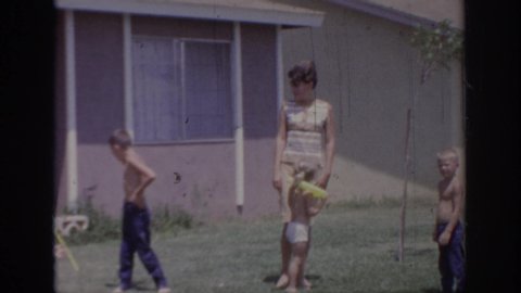 SACRAMENTO CALIFORNIA USA-1966: Family Enjoying Quality Bonding Time On A Gorgeous Summer Afternoon At Home