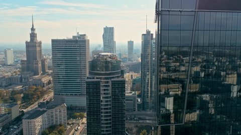 Establishing Aerial Panoramic View of Warsaw City Centre, Poland, Europe. Urban Skyline with Glass Skyscrapers and Main Landmark - Palace of Culture and Science. 4K Background Panning Reveal Shot