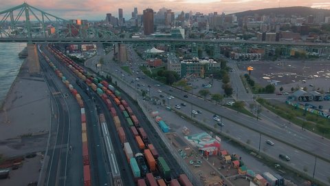 AERIAL: The railway, rush hour traffic, Pont Jacques-Cartier bridge, Saint Lawrence River and Montreal Skyline, Quebec, Canada 