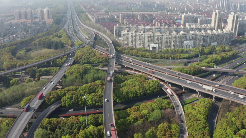 Aerial drone shot fly over the elevated road infrastructure with traffic scene in Shanghai, China