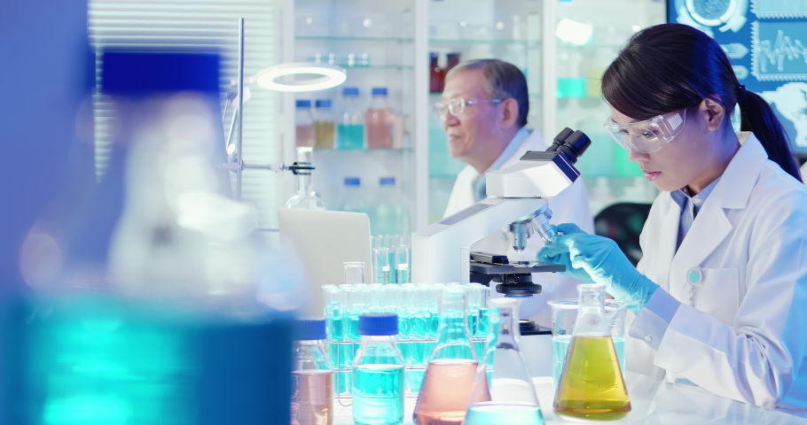 asian scientist team use microscope in the laboratory Royalty-Free Stock Footage #1042981780