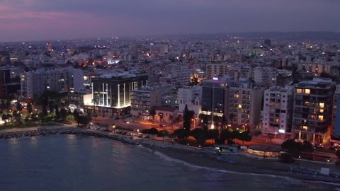 Aerial view of Limassol cityscape, first coastline buildings and Molos Park in Cyprus at night. Drone footage of mediterranean sea resort Limassol from above