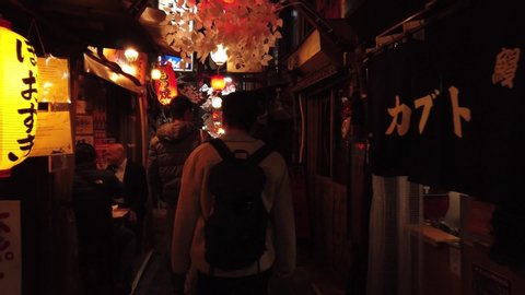 Video Walking in Omoide Yokocho walking street cafe bar and pub restaurant alley at night (Exit north gate). Shinjuku, Tokyo, Japan. 12 December 2019