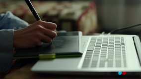 closeup woman's hands with pen tablet and laptop. woman freelancer retoucher working at home. Designer Drawing With Pen On Graphic Tablet. fullHD stock footage