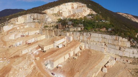 Air view of a marble quarry. Panoramic view of the extraction of marble in the quarry. Technique in the marble quarry of Brescia, Italy. Open pit mine. Aerial video with drone