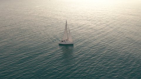 Aerial view. Yacht sailing on opened sea. Sailing boat. Yachting video footage. Yacht from above. Sailboat view from drone.