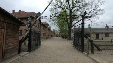 Oświęcim / Poland - April 27, 2019 - SLOW MOTION SHOT - Holocaust Memorial Museum. The Auschwitz I concentration camp was established in June 1940. The Arbeit Macht Frei Gate (work will set you free).