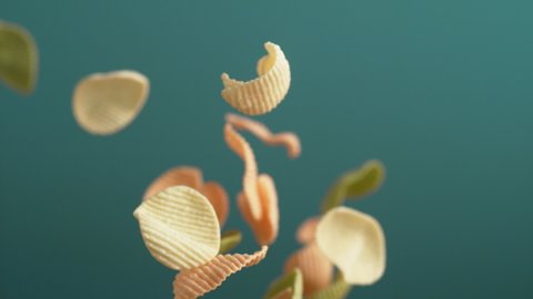 Camera follows potato chips flying in the air. Slow Motion.